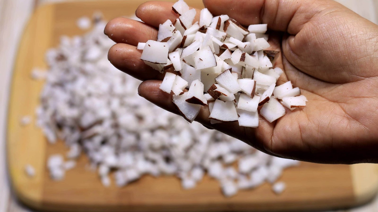 Shell and dice the coconut into smaller pieces